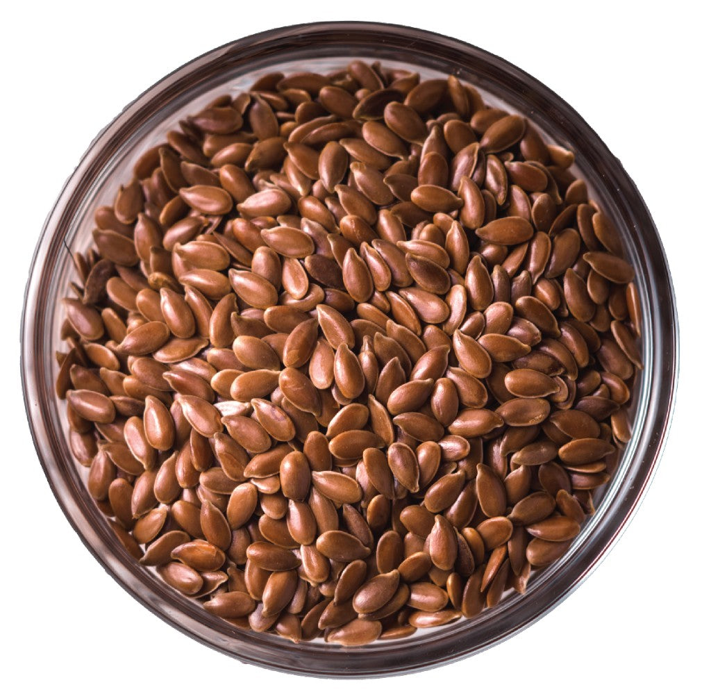 Carniwel Pet Food Food Ingredients - Close-up of a bowl filled with brown flaxseeds on a white background